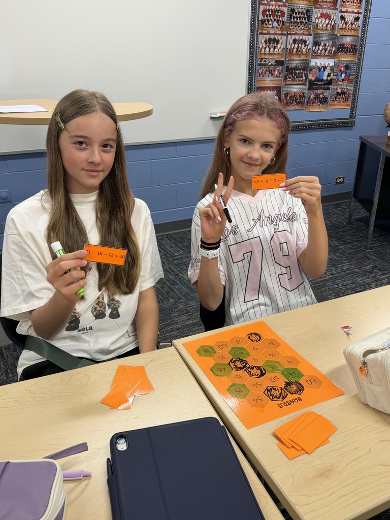 2 girls doing a math project.
