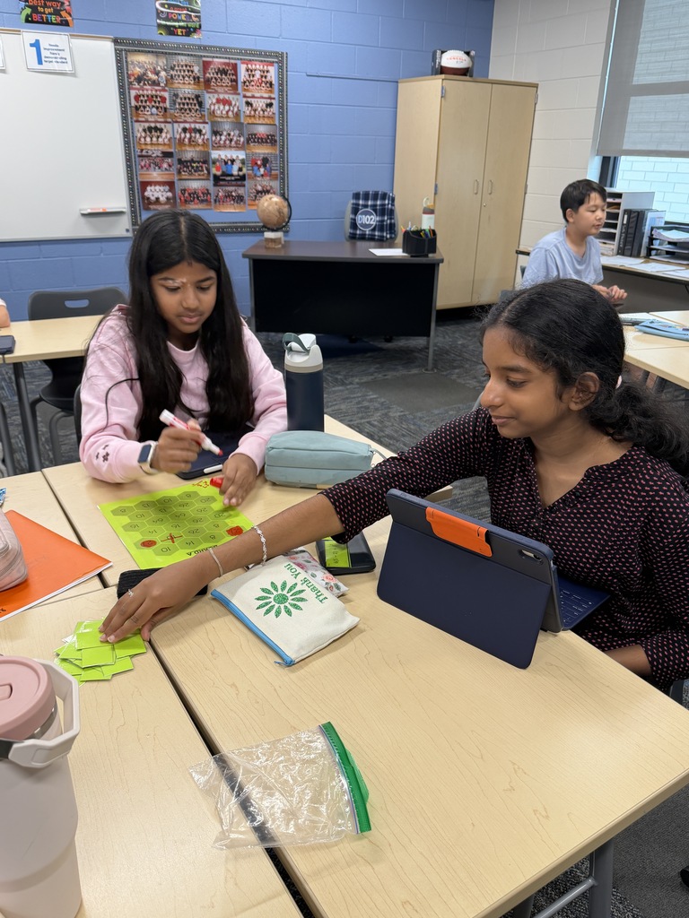 2 girls doing a math problem.