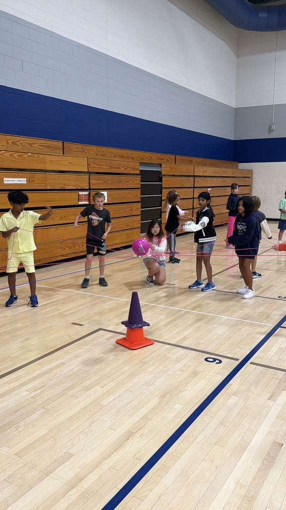 Several students getting the ball on the cone.