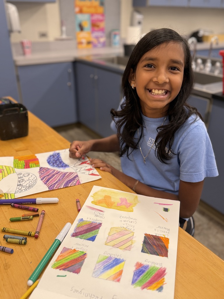 Smiling girl with her artwork.