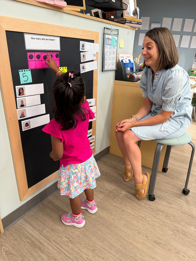 Teacher watches a student count.