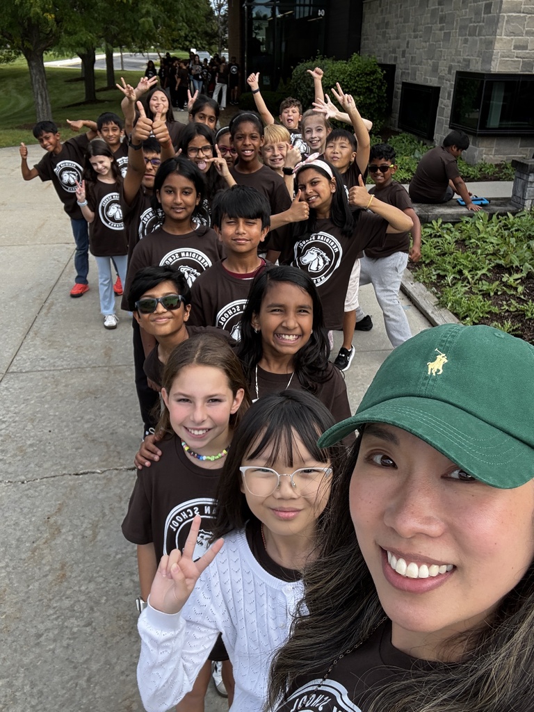 Teacher takes a selfie with her class.