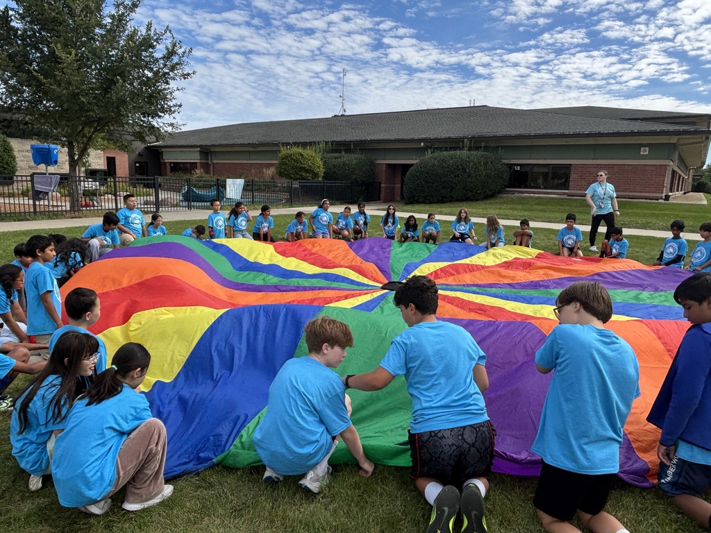 Parachute with students sitting around the edge.