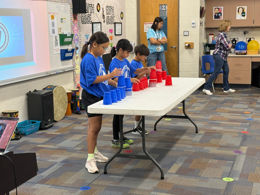 Students playing a cup game.