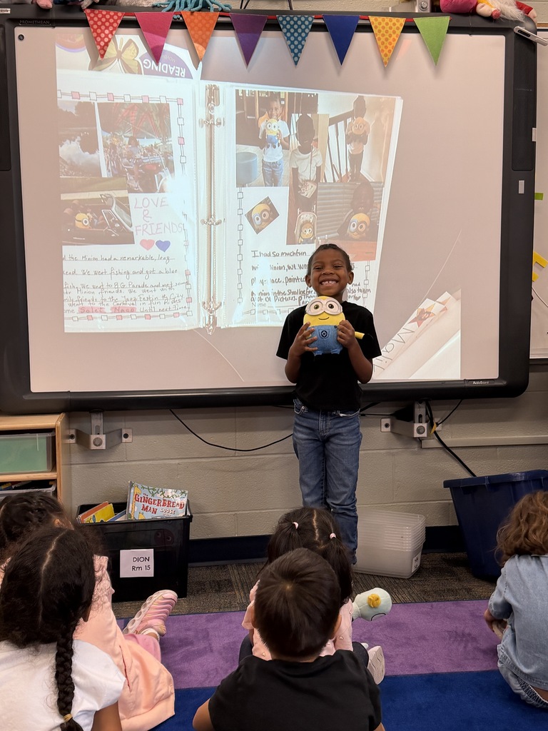 Student standing in front of the class with the minion.