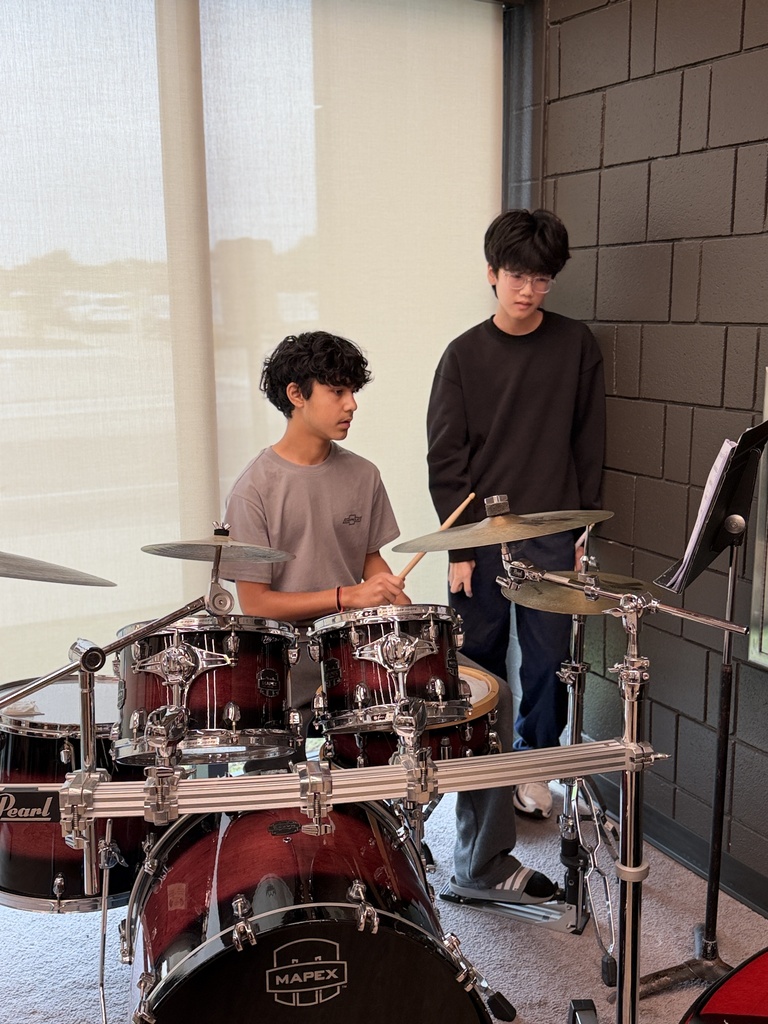 2 boys playing the drums.