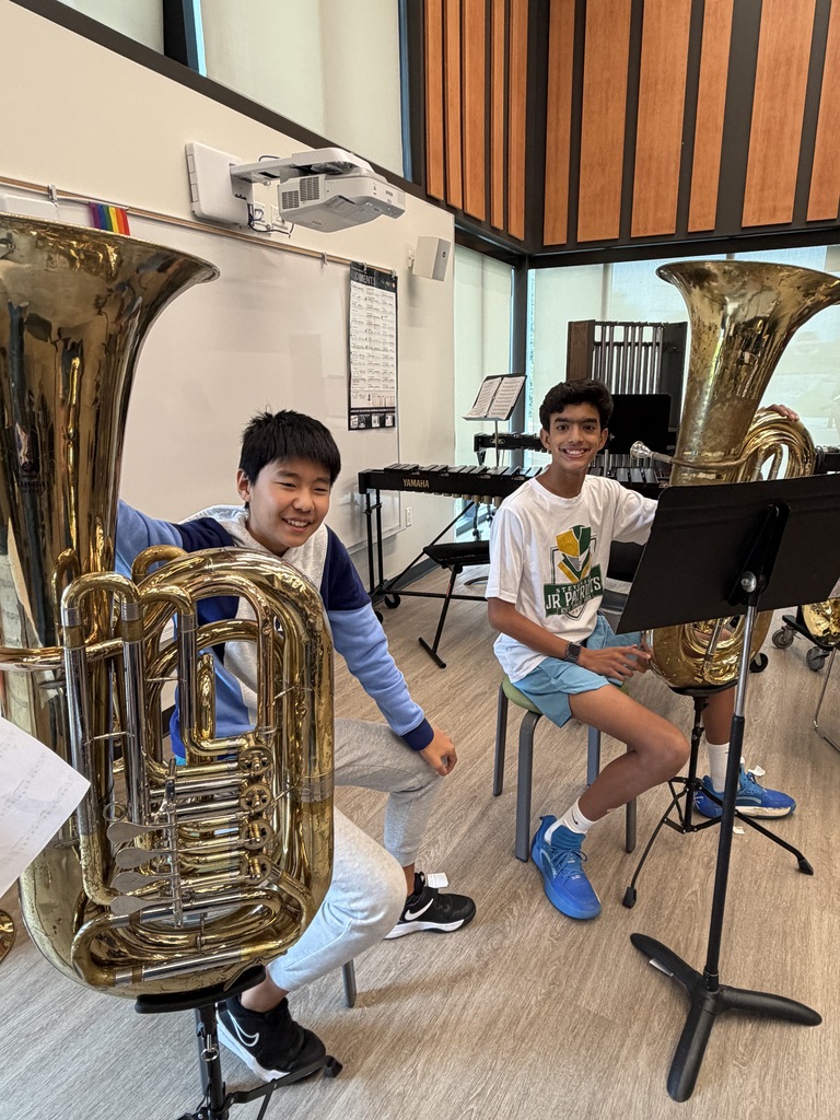 2 boys holding an instrument.