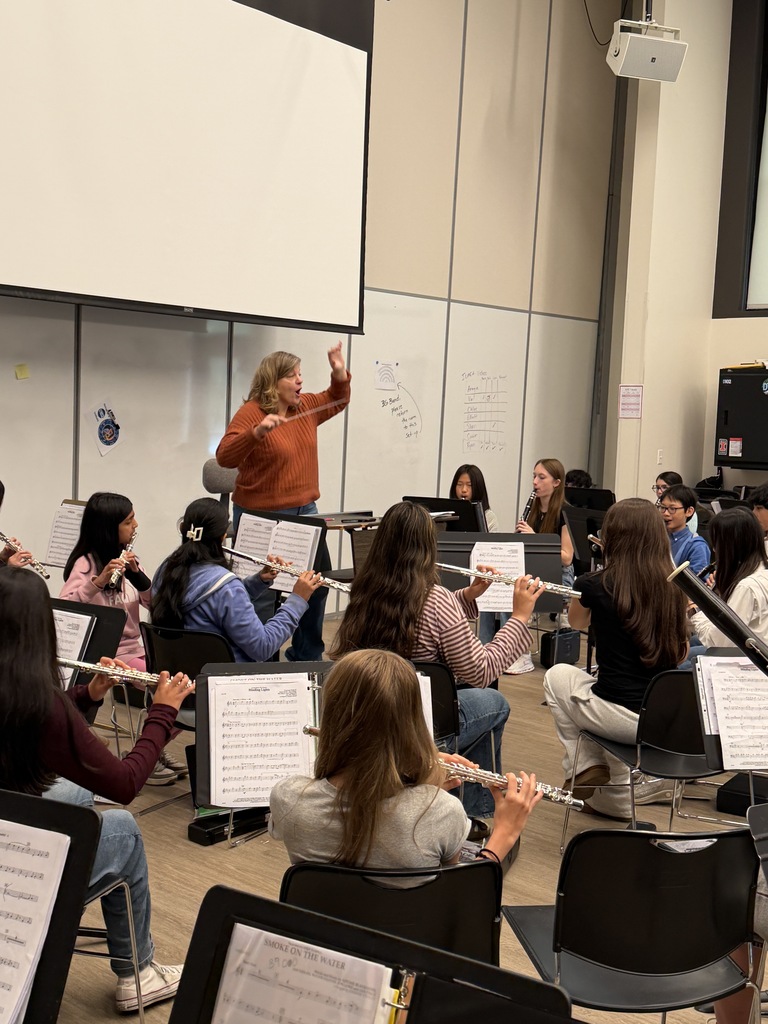 Mrs. Rakickas directing music at the front of the room.