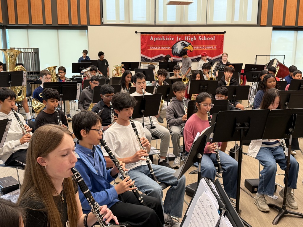 a room full of students playing music. 