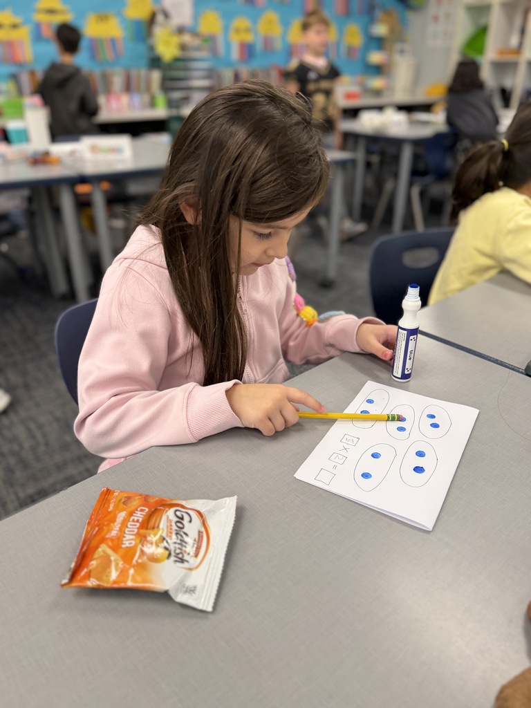 1 student working with paper and dot painters.