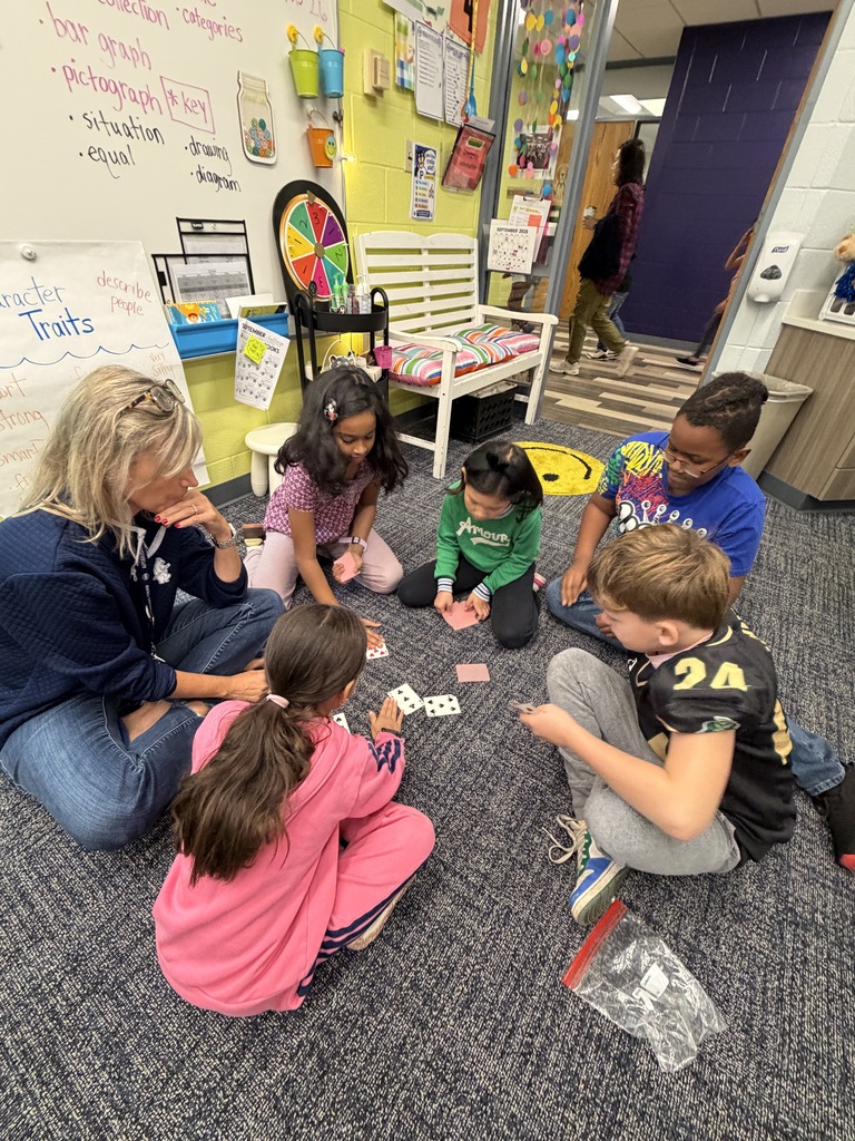Mrs. Fasuna playing a game with students. 