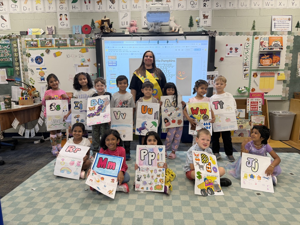 class posters with the teacher.