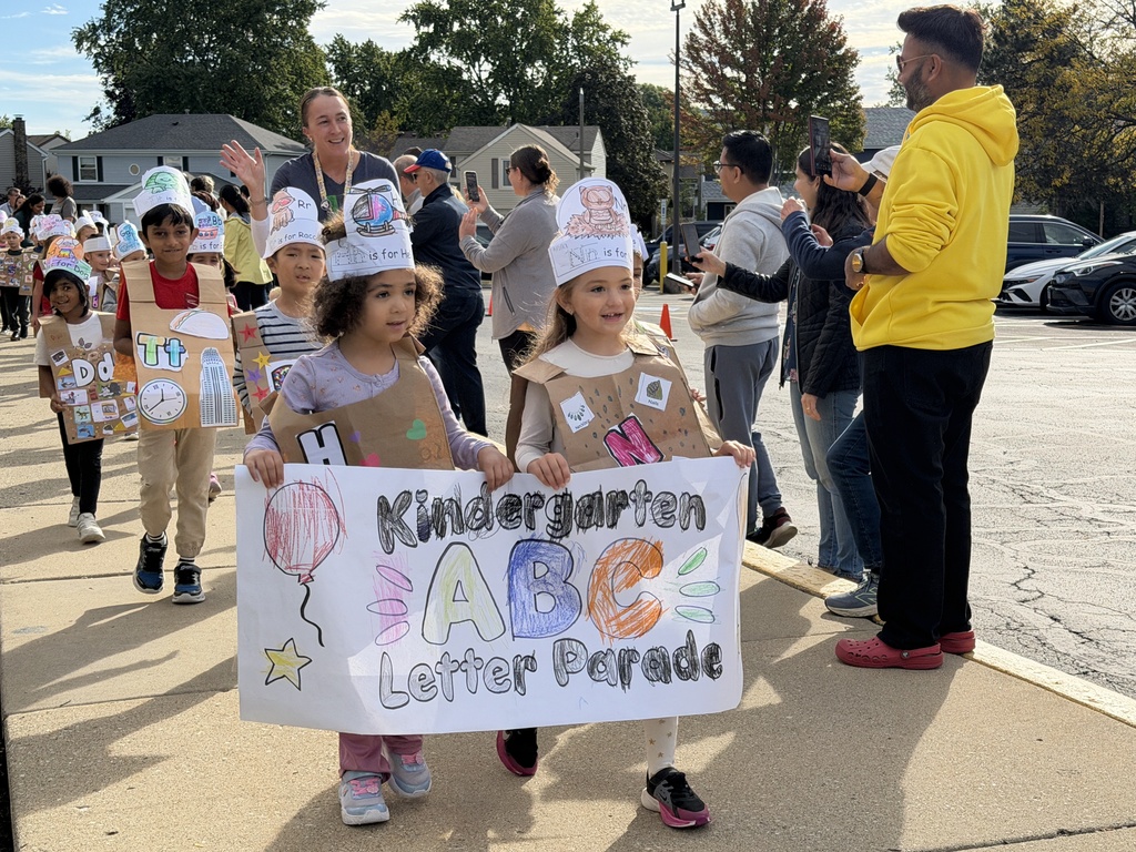 2 girls holding a poster.