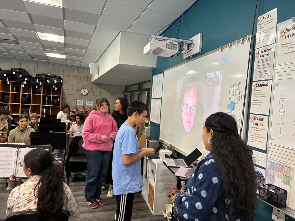 Student talking in front of the computer to the presenter on Zoom.