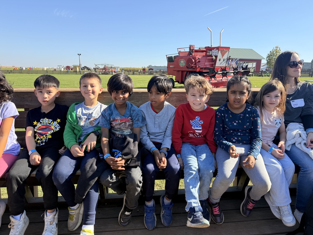 Students sitting on a hay ride.