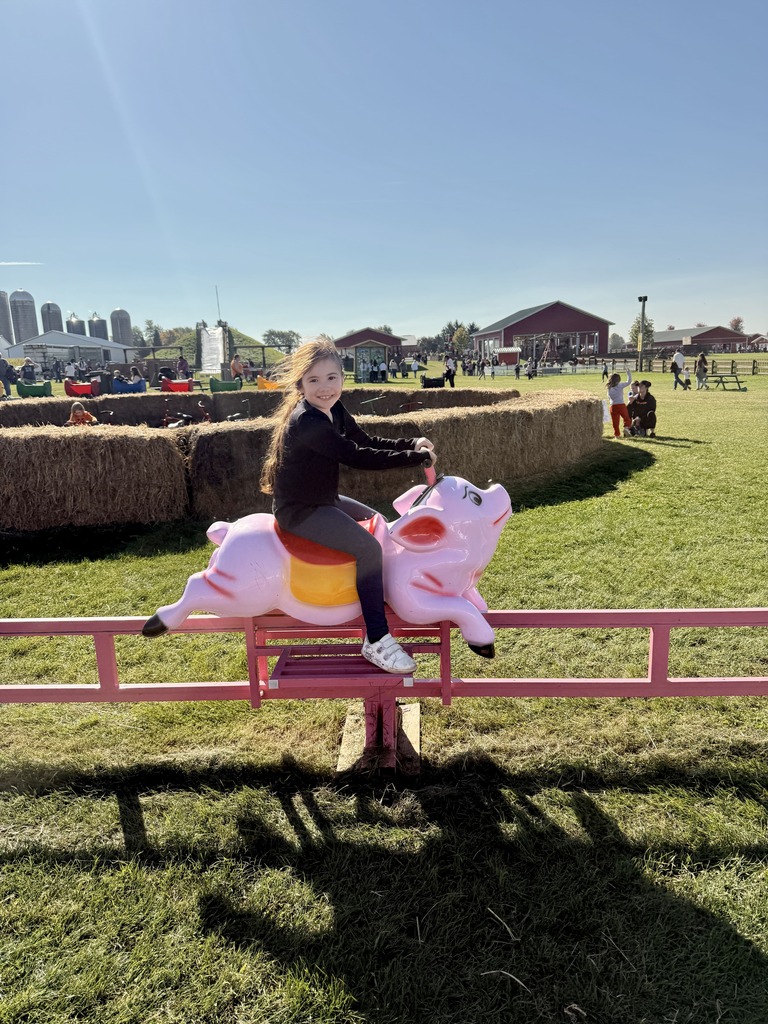 Student riding a pig ride.