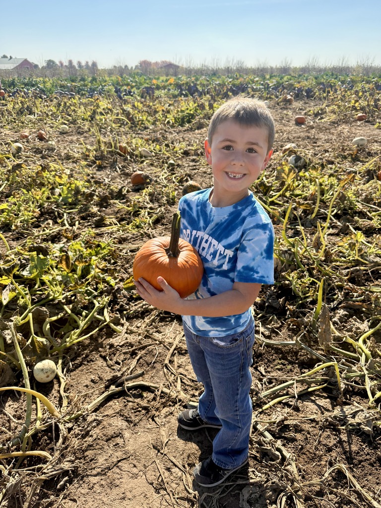 Student holding a pumpkin.