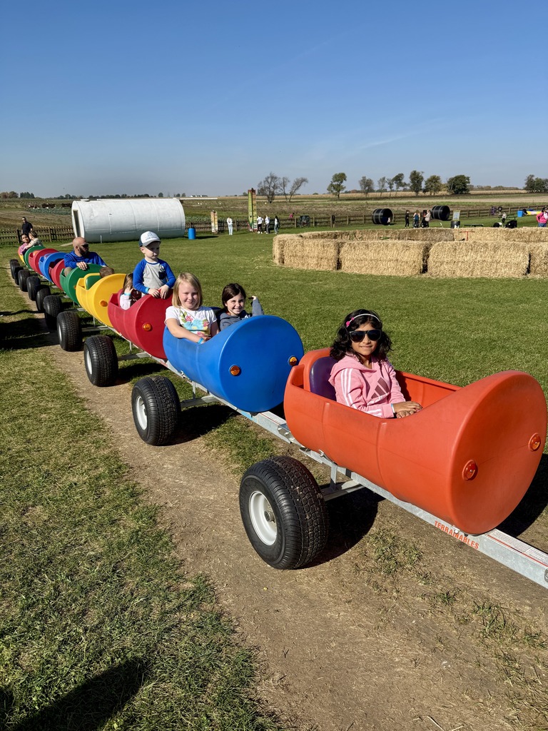 Students going on a tractor ride on the farm.