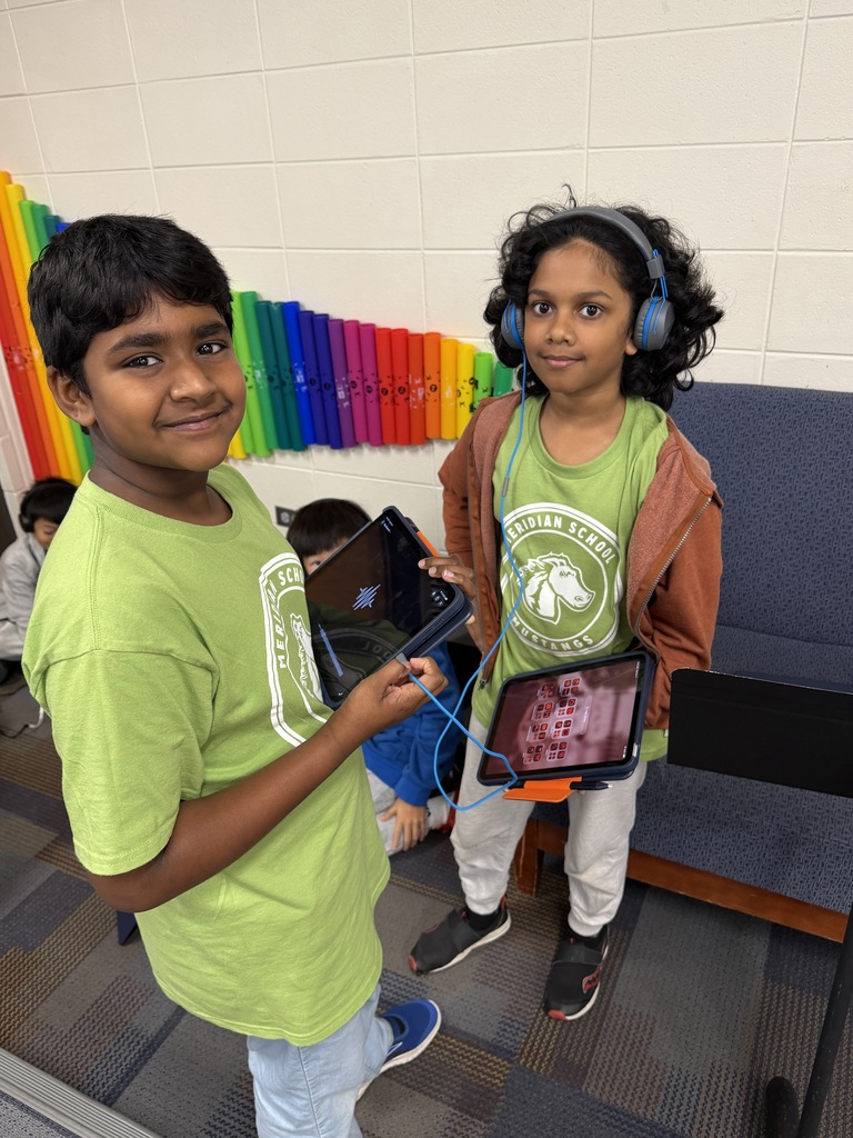 2 students holding ipads