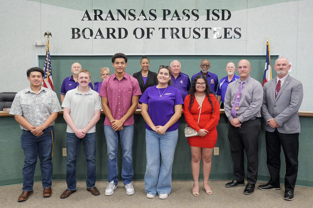 students being recognized at a school board meeting