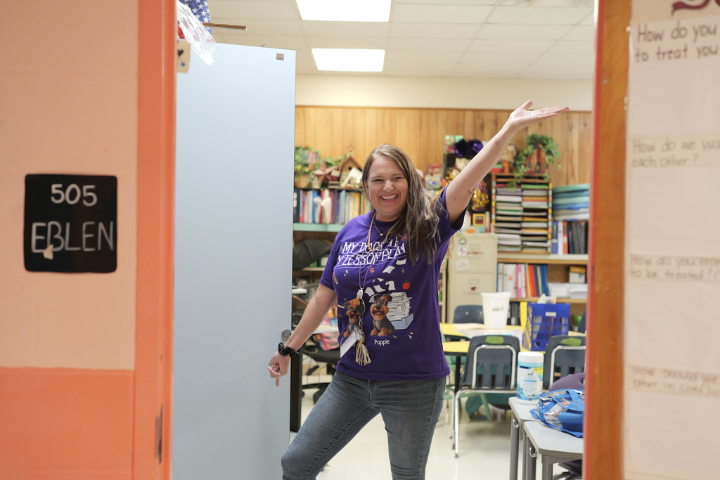 Woman standing with her arms stretched out, smiling