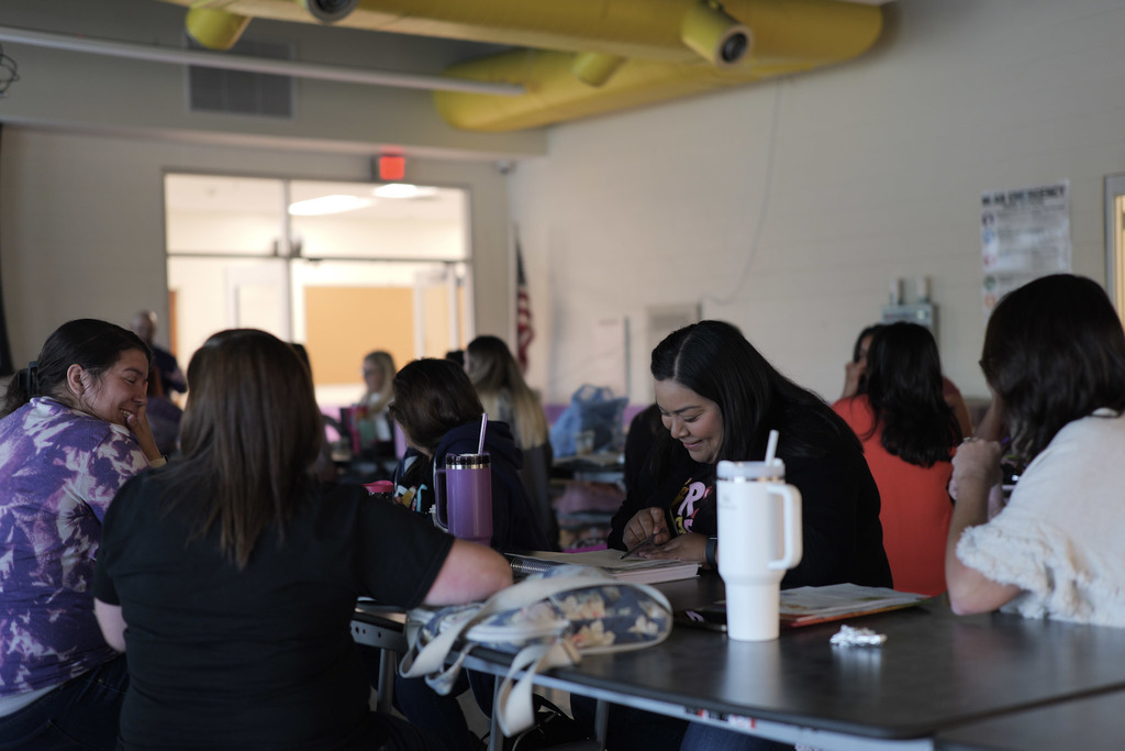 Group of teachers sitting at a table in a cafeteria
