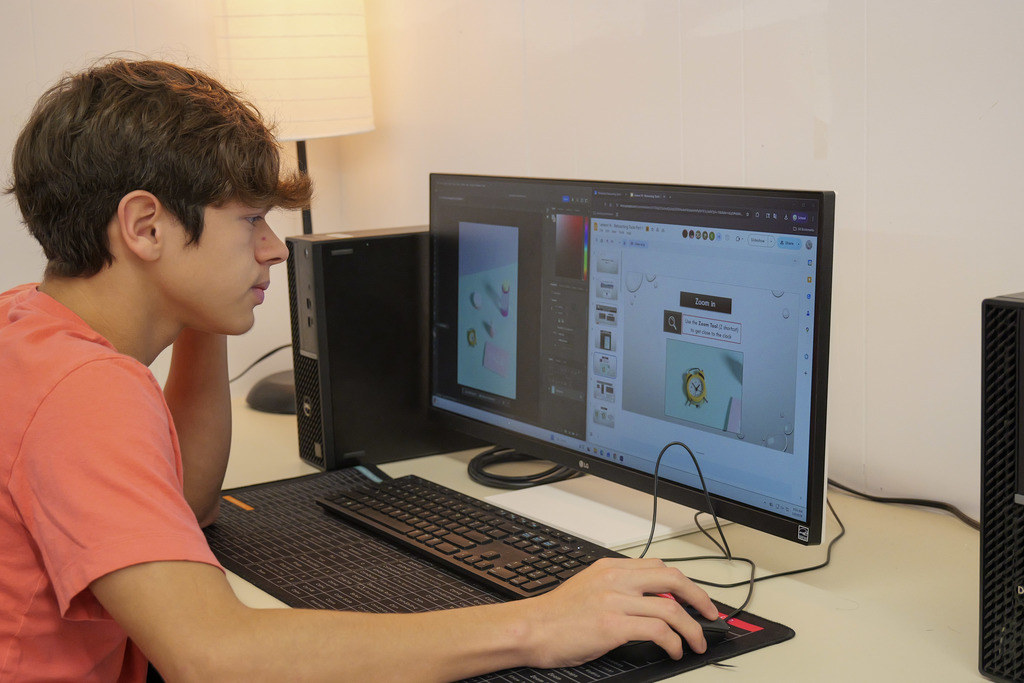 student working on a computer using Photoshop