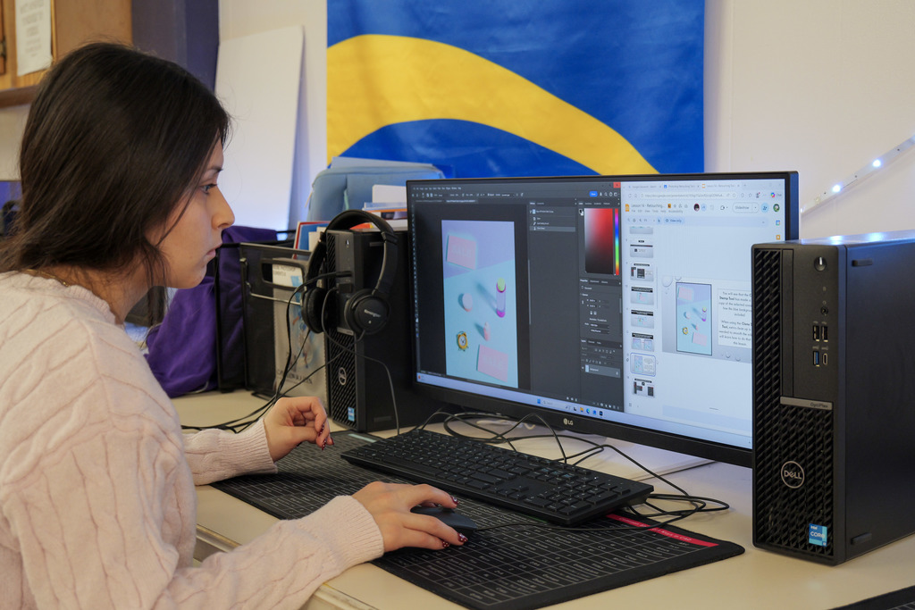 student working on a computer using Photoshop