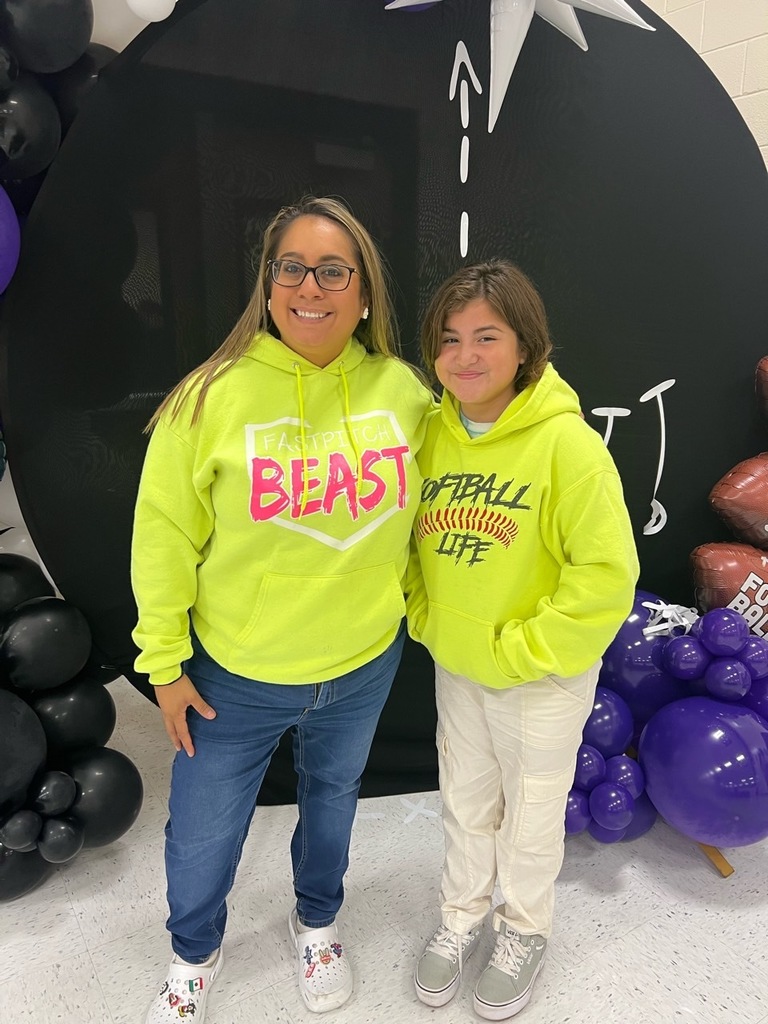 Teacher and student standing in front of black background