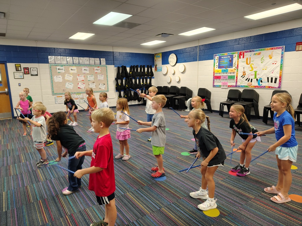 Students playing rhythm sticks