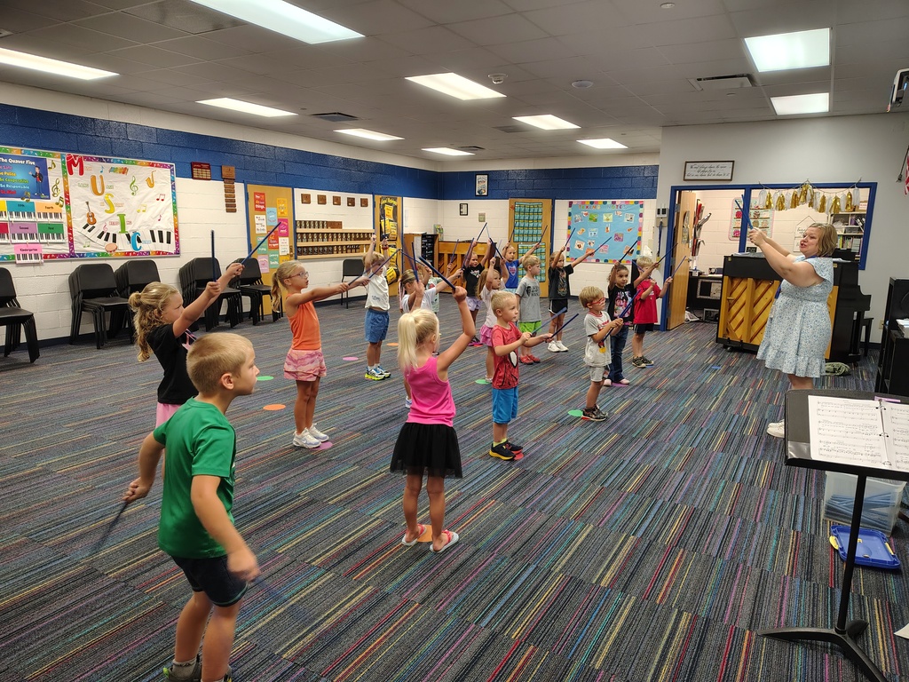 Students playing rhythm sticks