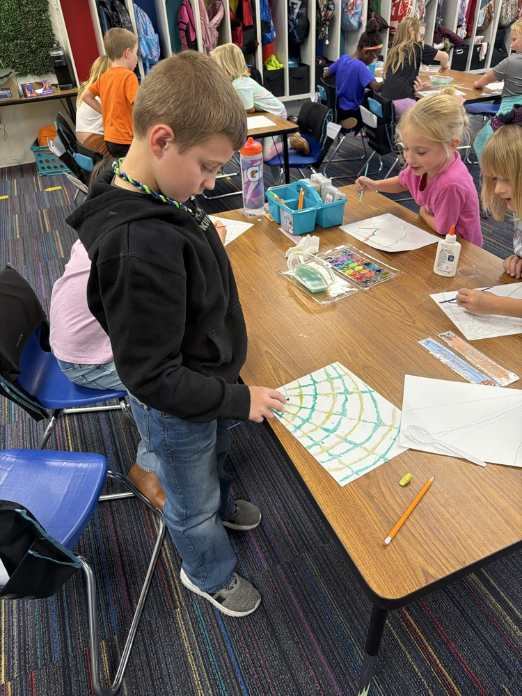 Students drew a web, covered it with glue and salt, then painted with watercolor!