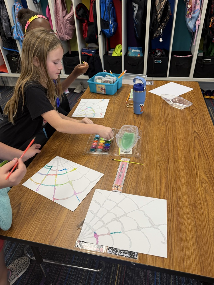 Students drew a web, covered it with glue and salt, then painted with watercolor!