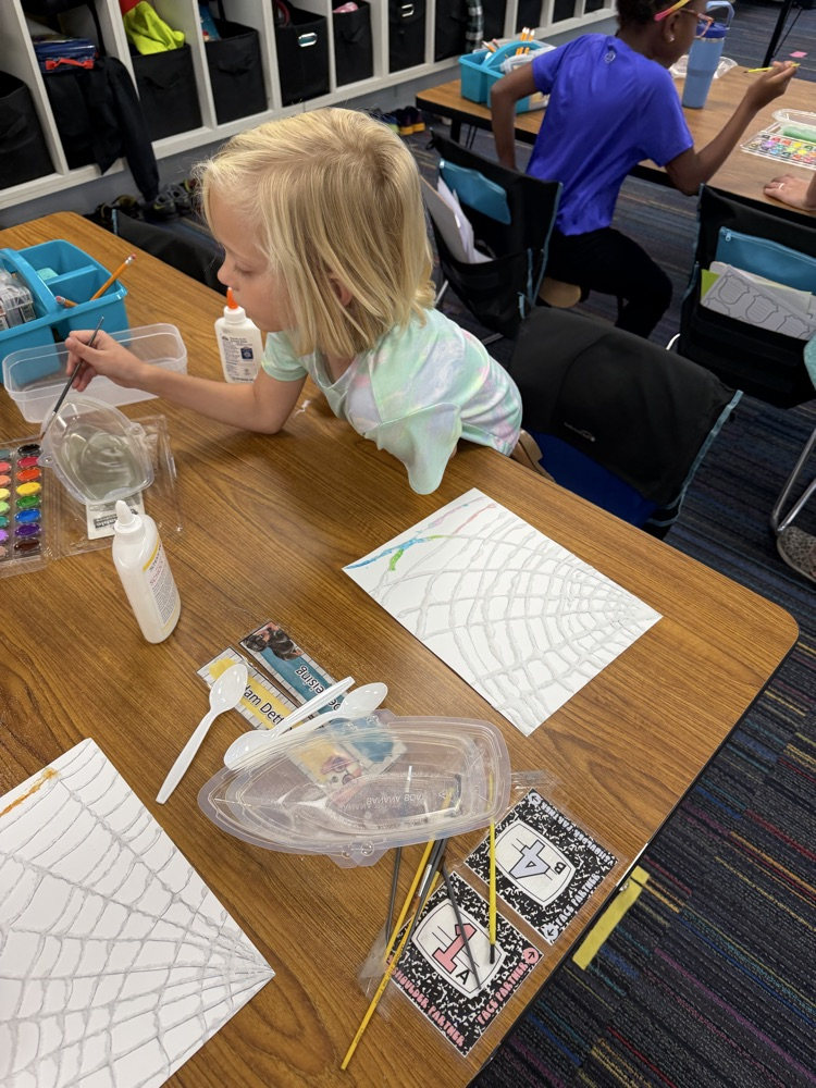 Students drew a web, covered it with glue and salt, then painted with watercolor!