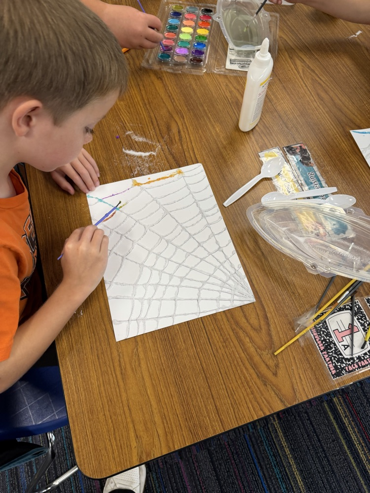 Students drew a web, covered it with glue and salt, then painted with watercolor!