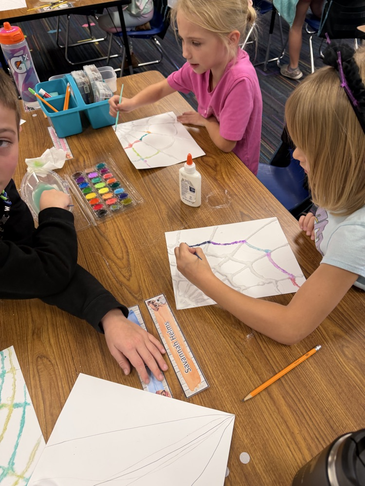 Students drew a web, covered it with glue and salt, then painted with watercolor.