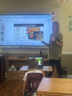 Elementary teacher uses a slide show to teach about the calendar.