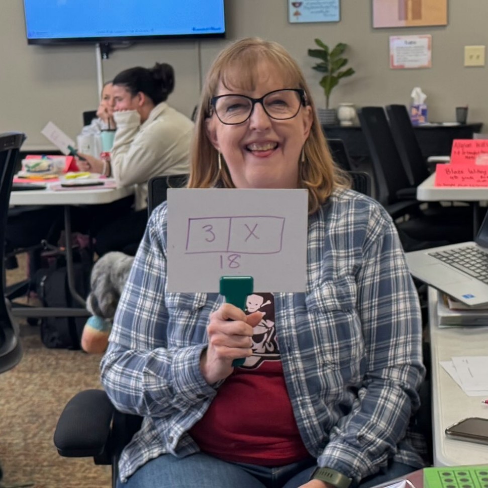Teachers holding up sign