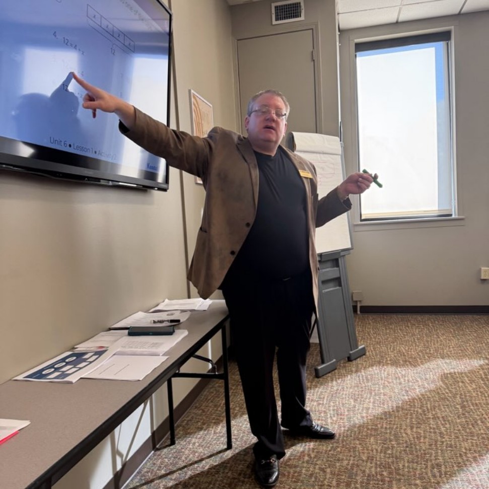 Teacher pointing to board