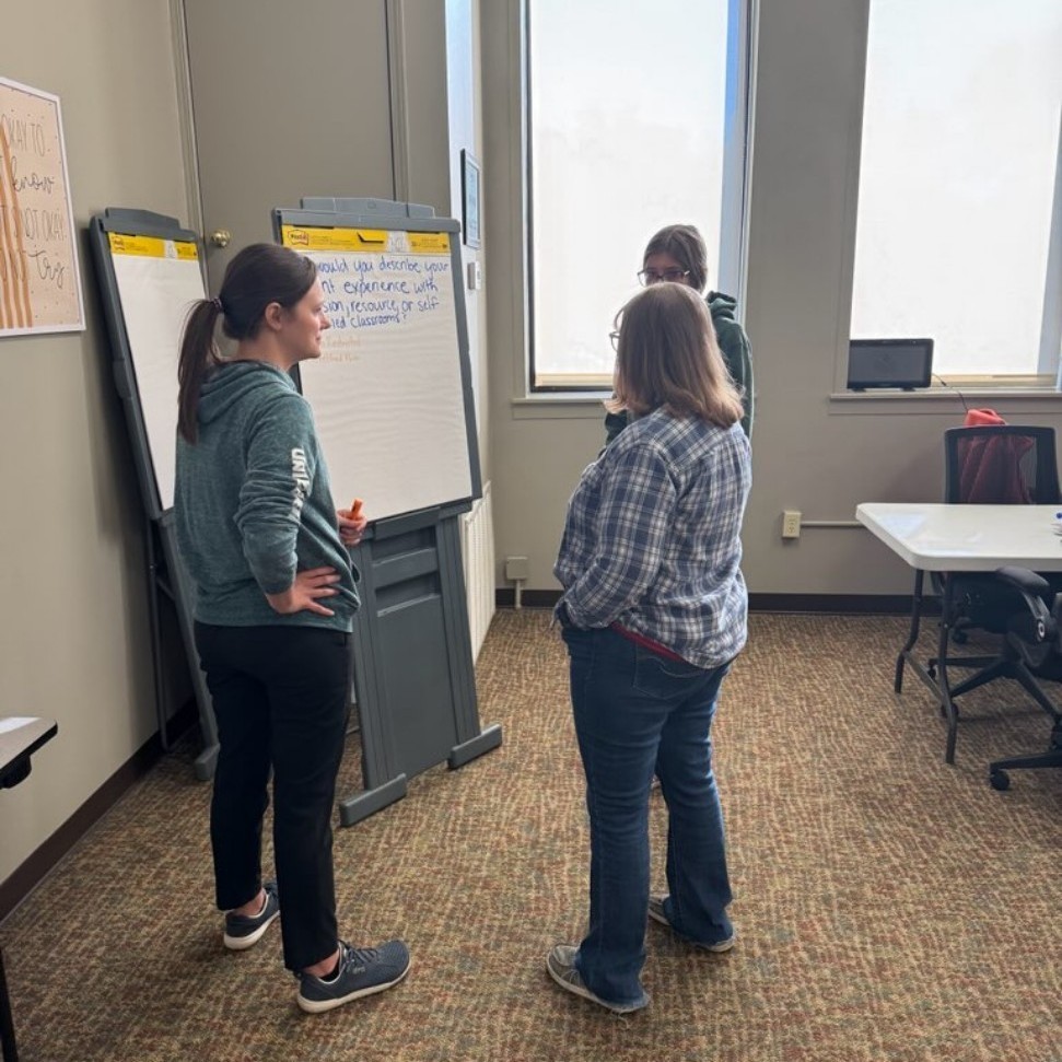 Teachers talking around board