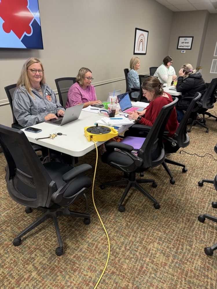 Three contacts sitting together and collaborating during the meeting. 