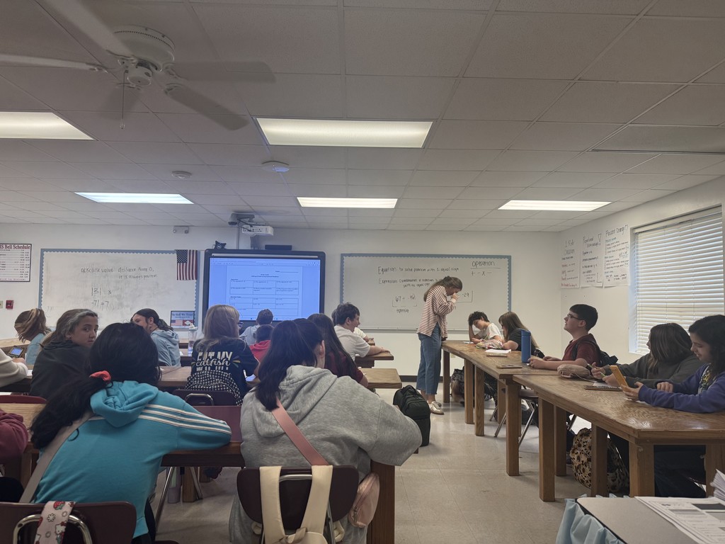 Teacher assisting student understanding during individual work. 