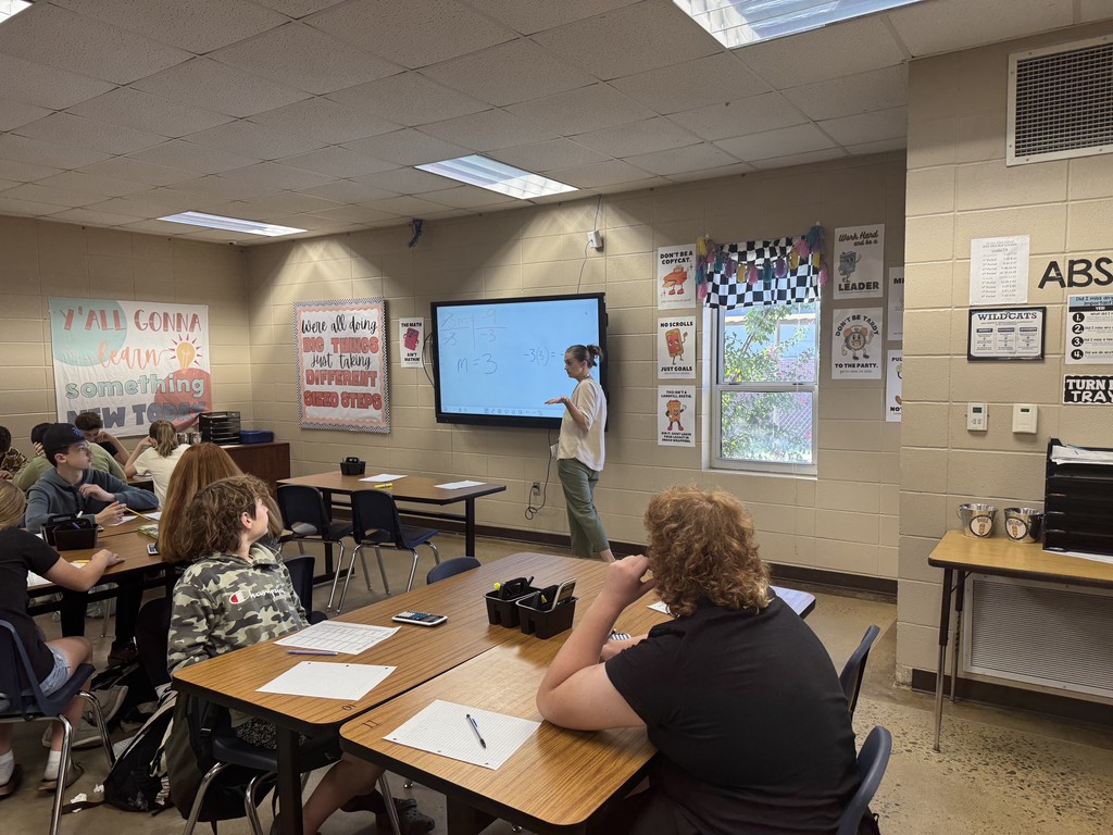 Teacher presenting a lesson with students listening. 