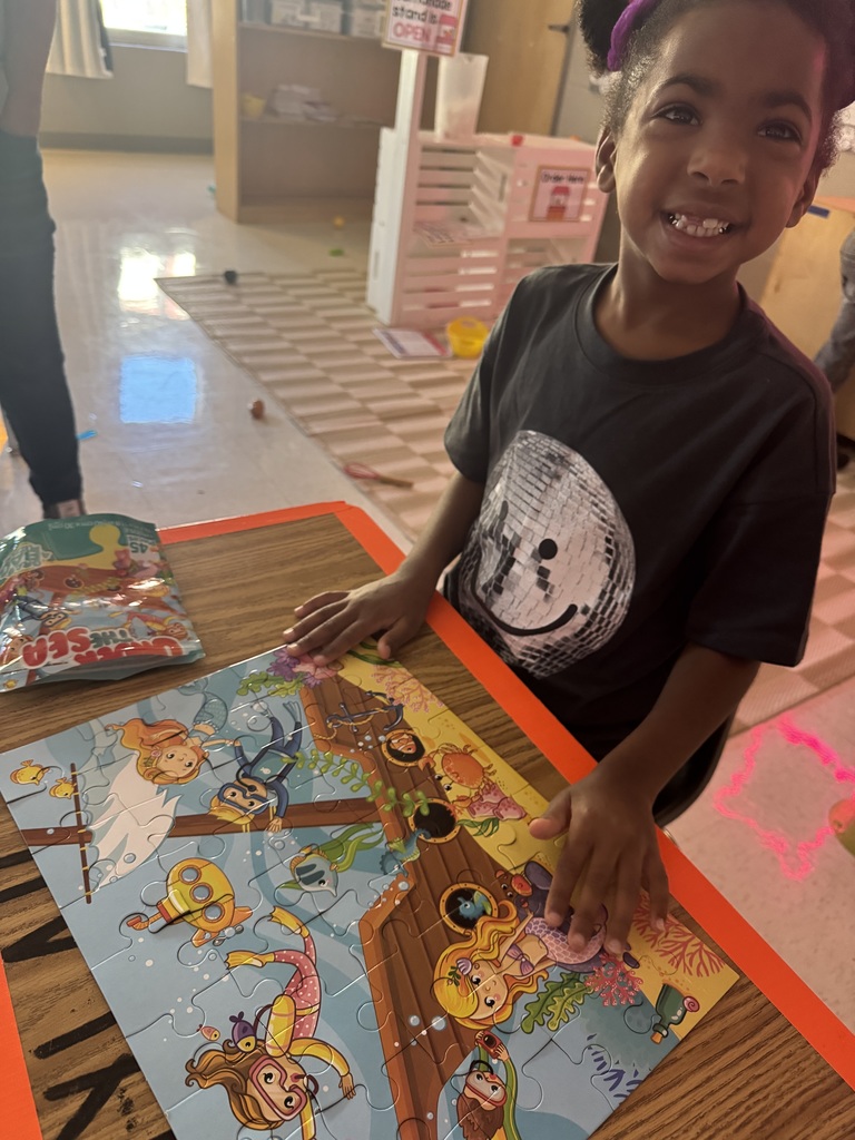 Student showing off a finished puzzle. 