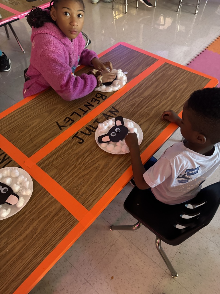 Students working on their cotton ball lambs.