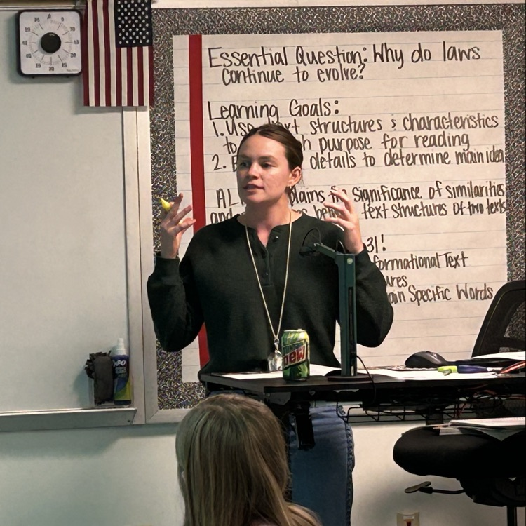 Teacher at the front of the room teaching  