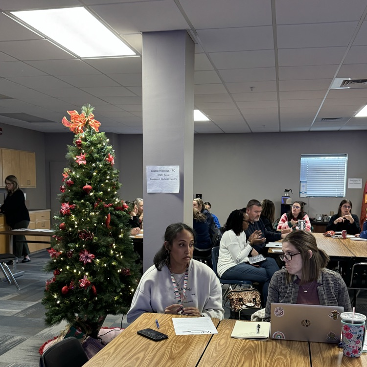 groups of teachers sitting at tables discussing student engagement  