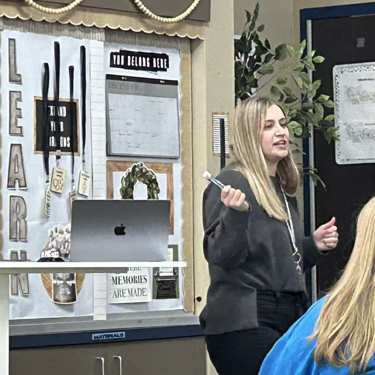 Teacher at the front of the room teaching  