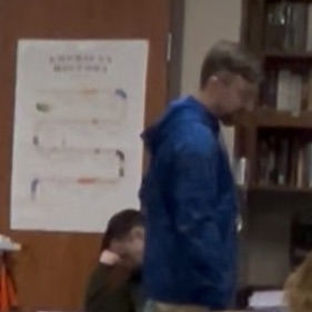 Teacher helping students at their desks  