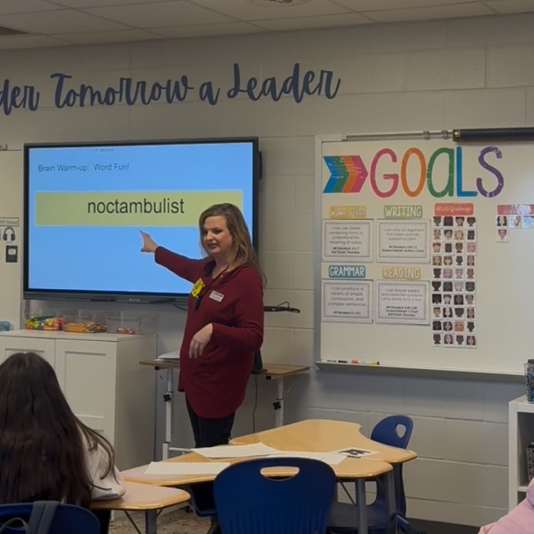 Teacher at the front of the room helping students to break down the word noctambulist  